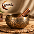 Lotus-Engraved Gold-Tone Singing Bowl — Signature scene